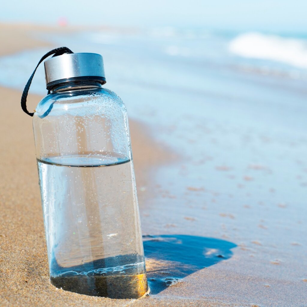 reusable water bottle on beach